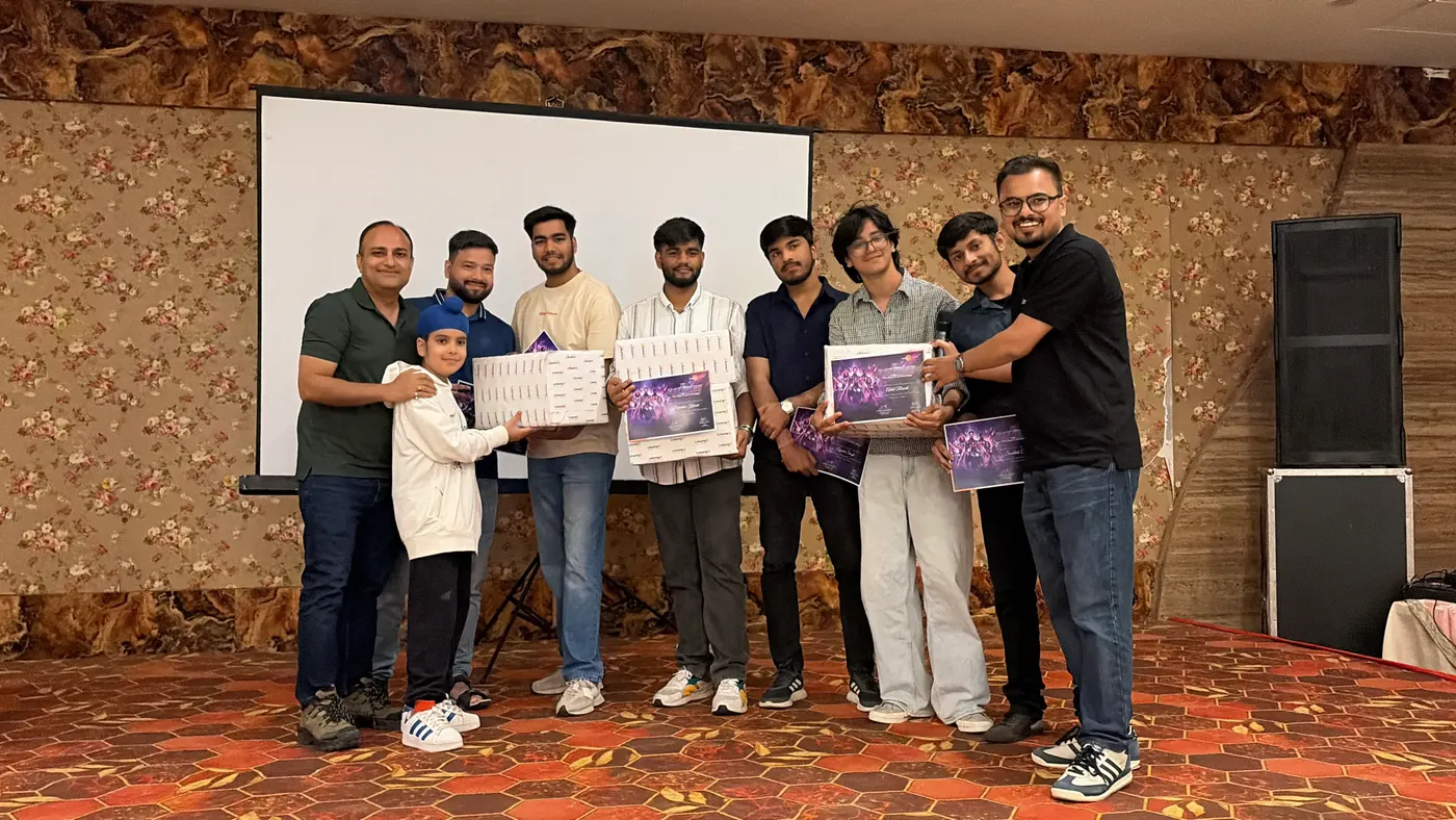 Team members holding their awards on stage